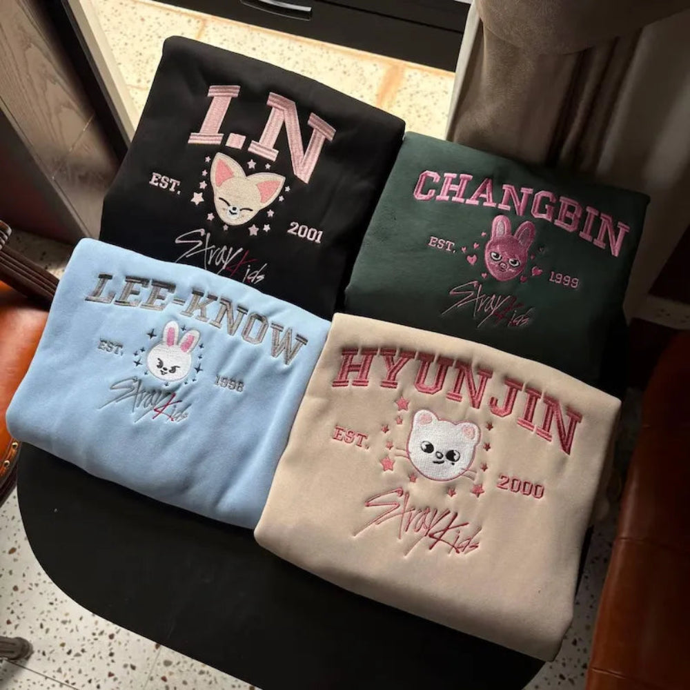 Assorted SKZOO Varsity Sweatshirts On Couch, Changbin To Hyunjin