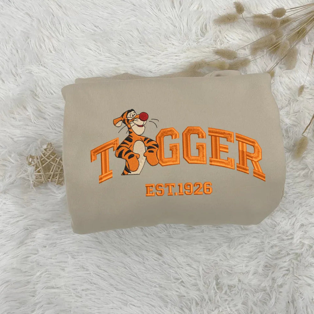 Folded Sand Tigger Embroidered Sweatshirt With Orange Varsity Text
