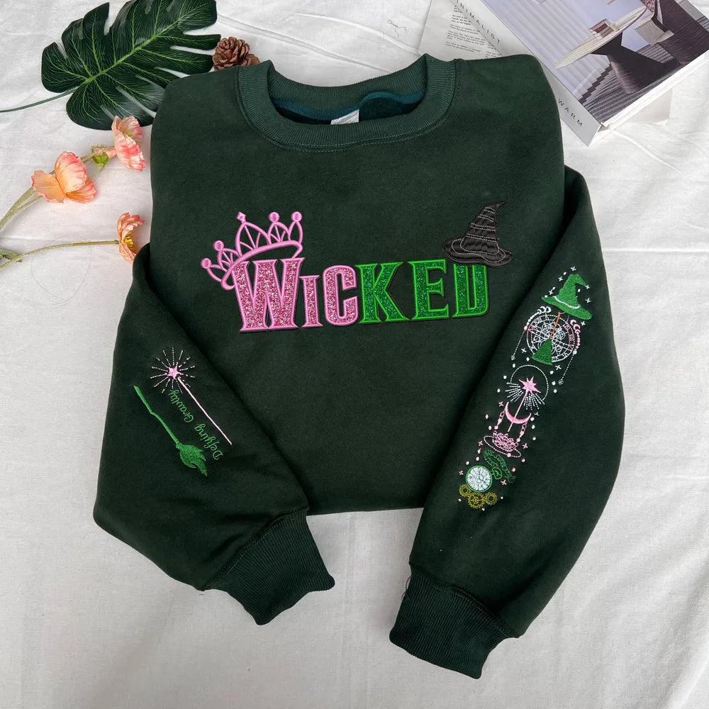 Wicked Glimmer Crown And Wand Icons On Green Sweater