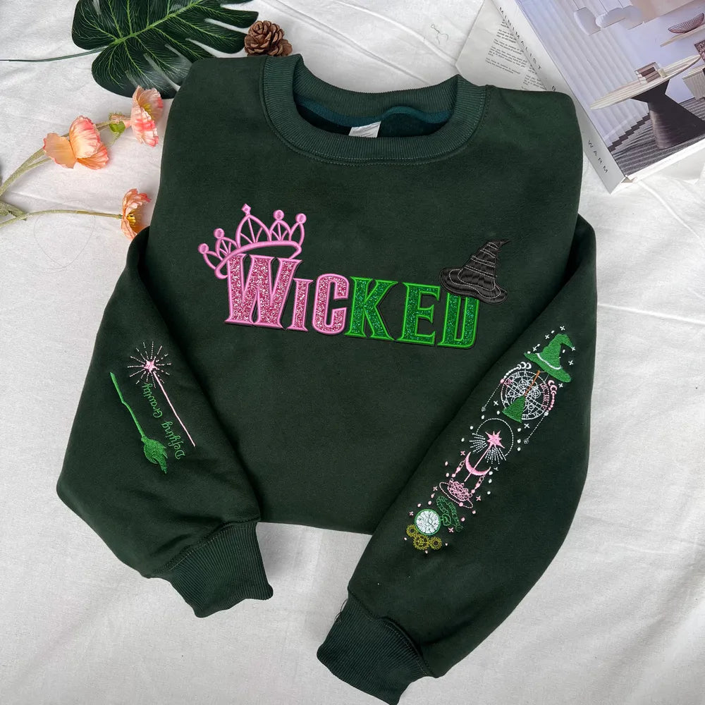 Wicked Glimmer Crown and Wand Icons on Green Sweater