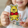 Child Holding Adorable Chibi Winnie The Pooh Patch With Shirt