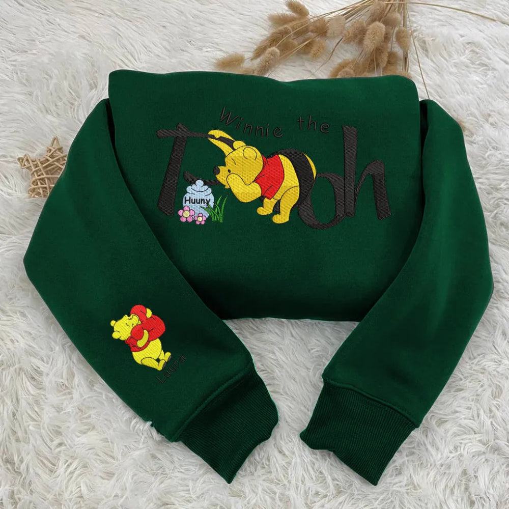Sweatshirt Winnie The Pooh Hunny Pot Embroidered Folded On Grass.