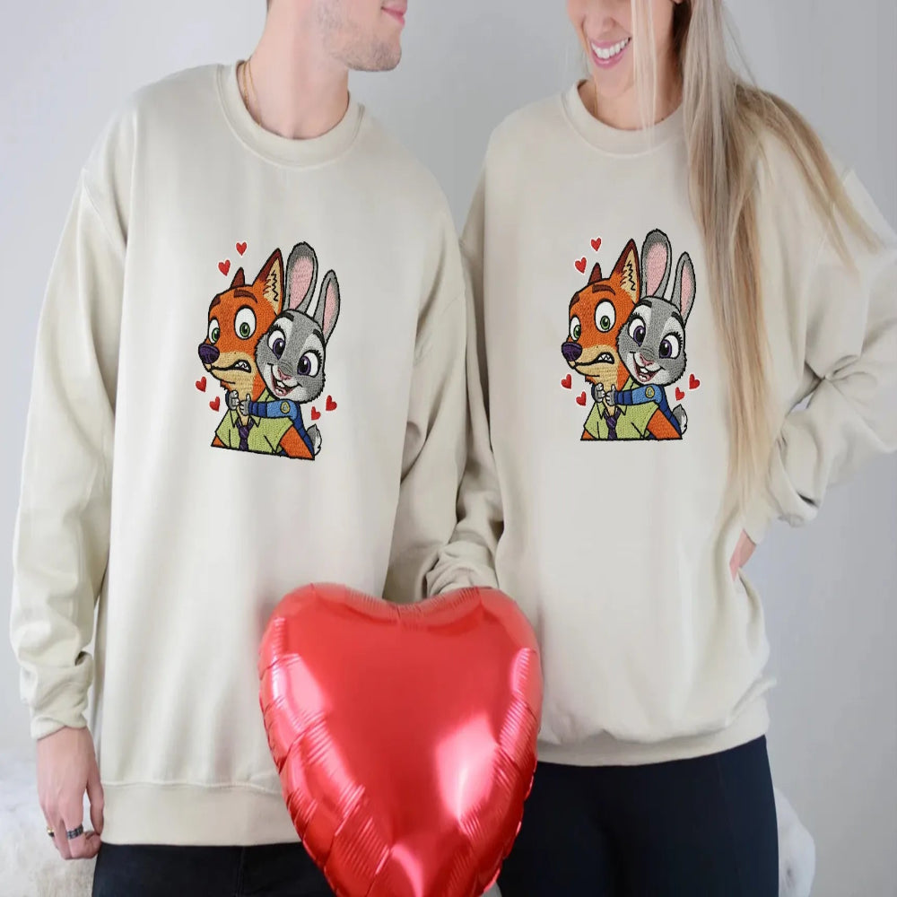 Couple In Matching Beige Zootopia Hoodies Holding Heart Balloon
